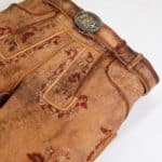 Vintage leather bag with intricate embroidery and a metal clasp.